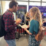 People talking at QUBIC booth at QAC